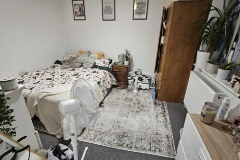 A cozy and well-decorated double bedroom featur...