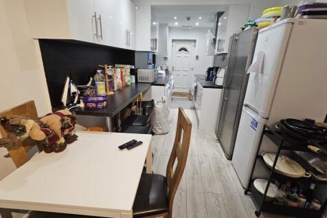 A modern, well-equipped kitchen featuring white...
