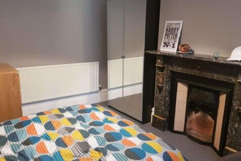 A cozy and inviting master bedroom featuring a ...