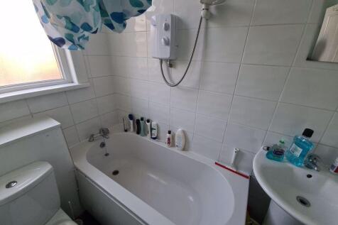 Bright and clean bathroom suite featuring a bat...