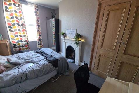 A cozy and well-lit double bedroom featuring a ...