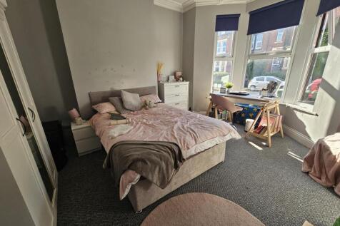 A bright and inviting master bedroom featuring ...