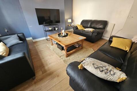 A welcoming living room featuring three black l...