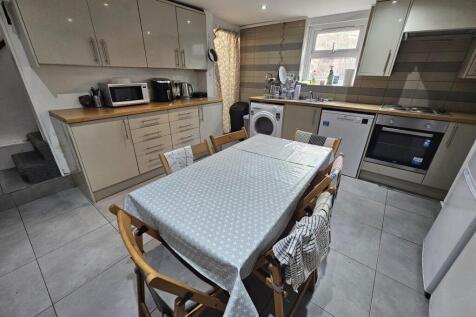 Modern kitchen with ample cabinetry, a dining t...