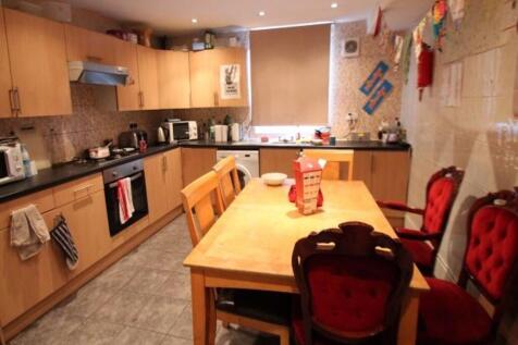 A warm and inviting kitchen featuring ample woo...