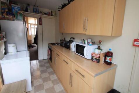 A tidy, well-organized kitchen featuring light ...