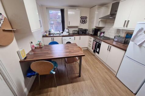 Bright and modern kitchen featuring ample count...