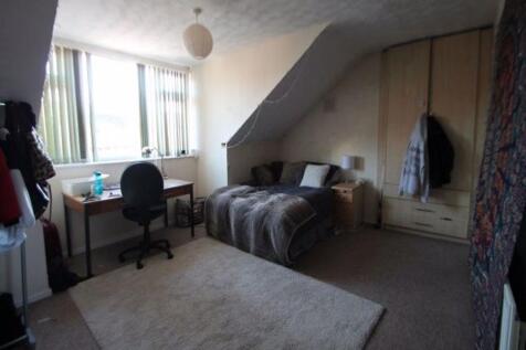 A cozy master bedroom featuring a comfortable d...