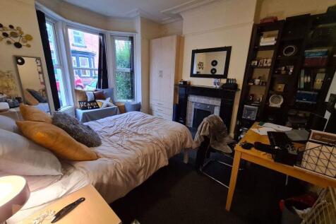A cozy and inviting master bedroom featuring a ...
