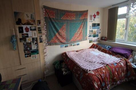 Cozy double bedroom with a large window offerin...