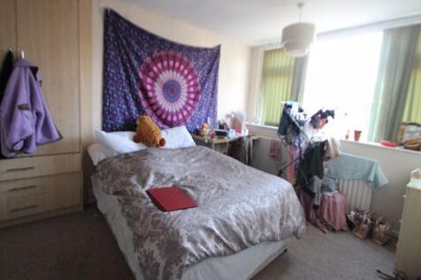Cozy single bedroom featuring a comfortable bed...