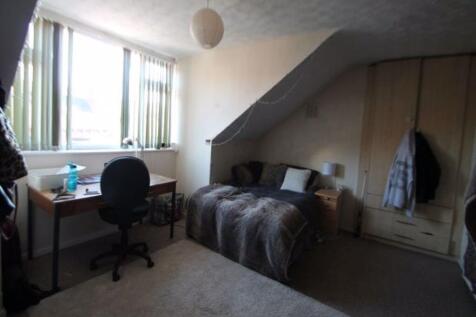 A cozy single bedroom featuring a comfortable b...