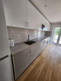 A modern, well-maintained kitchen featuring sle...