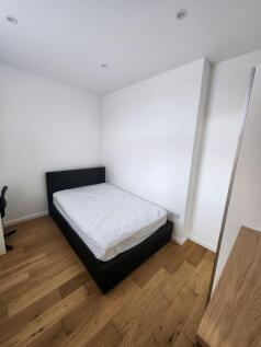 A clean and modern double bedroom featuring a b...