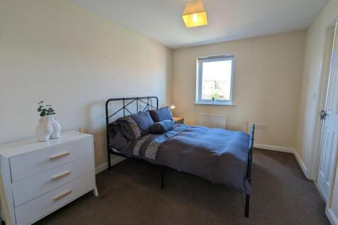 Bright and tidy double bedroom featuring a styl...