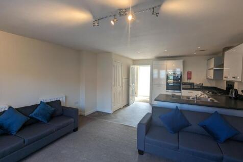 A modern and tidy open-plan living room with tw...