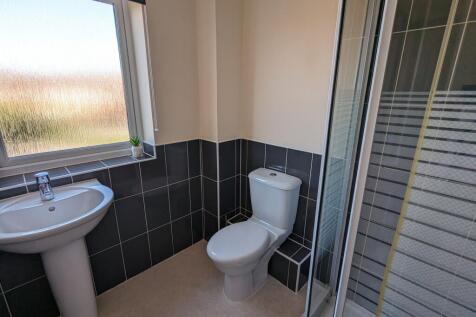A clean and modern bathroom featuring a white p...