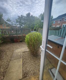 A charming garden space featuring a gravel grou...