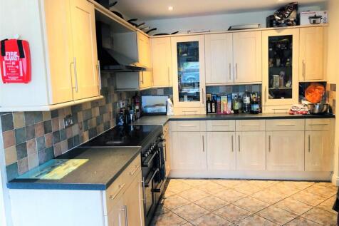 Modern kitchen featuring ample storage and work...