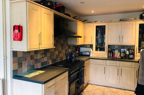 This modern kitchen features ample storage with...
