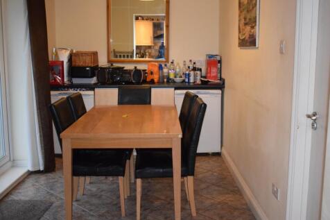 A cozy kitchen area featuring a dining table fo...
