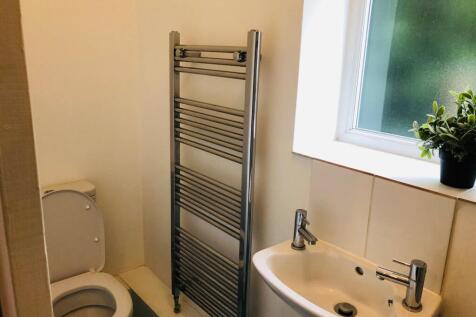 A clean and bright bathroom featuring modern fi...