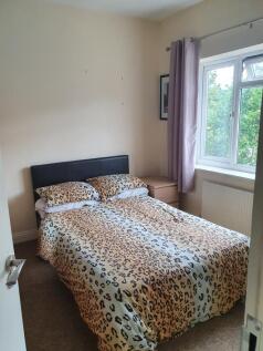 Cozy double bedroom featuring a stylish leopard...