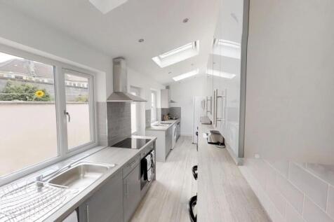 A modern kitchen featuring sleek cabinetry, amp...