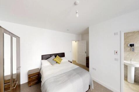 A well-appointed double bedroom featuring a coz...