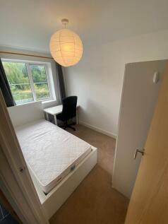 This cozy double bedroom features a large windo...