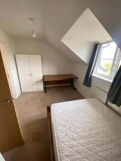 This charming double bedroom features a cozy at...
