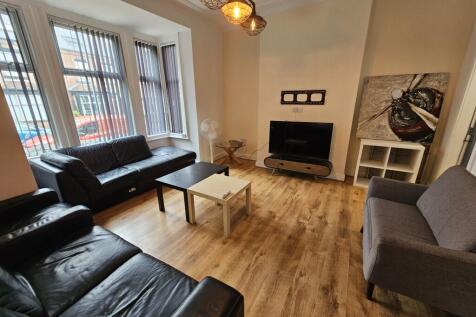 Spacious and well-lit living room featuring lar...
