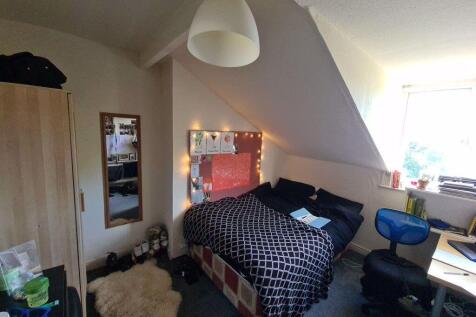 Cozy and well-lit master bedroom featuring a do...