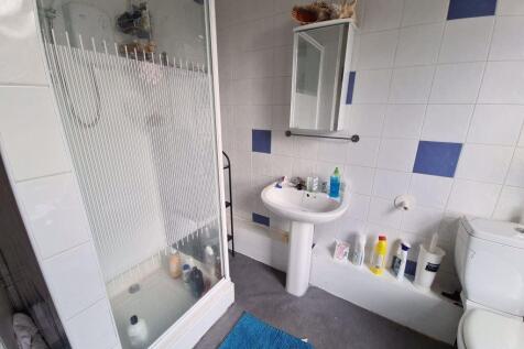 Bright and clean bathroom featuring a shower en...