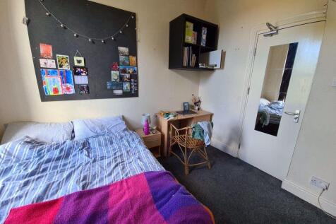 Cozy single bedroom featuring a comfortable bed...