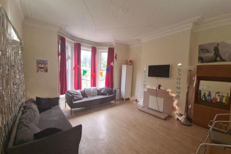 A bright and inviting living room with a bay wi...