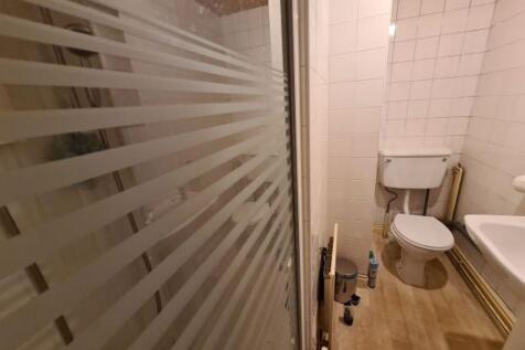 A neat and functional bathroom featuring a walk...