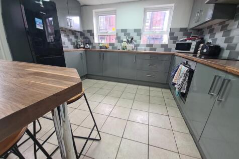 A modern kitchen featuring sleek cabinetry with...