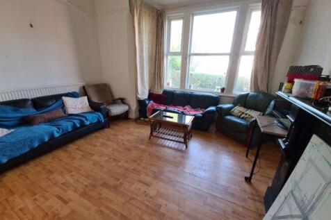 Bright and welcoming living room with large bay...