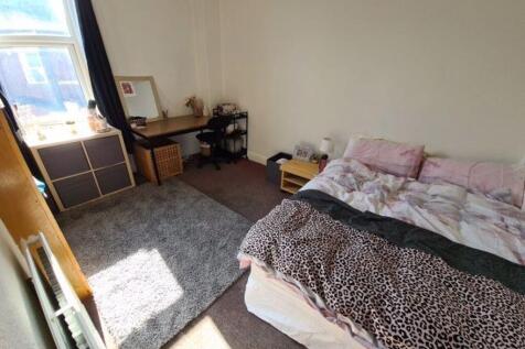 A cozy double bedroom featuring a large window ...