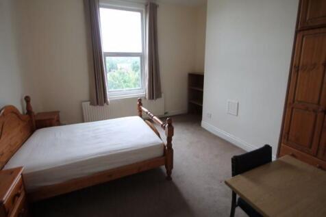 A simple and tidy double bedroom featuring a wo...