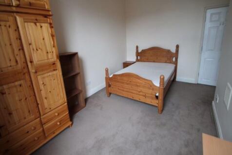 A tidy double bedroom featuring a wooden double...