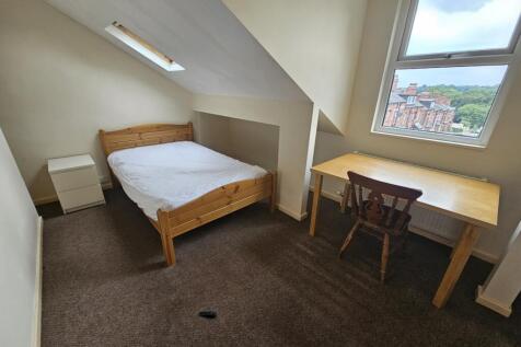 Cozy double bedroom featuring a comfortable woo...