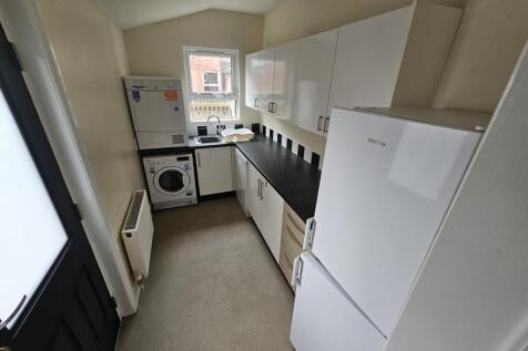 Bright and tidy kitchen featuring modern white ...