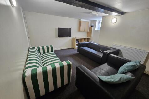 A cozy communal lounge featuring a mix of comfo...