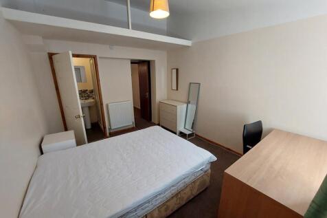 Spacious double bedroom featuring ample natural...