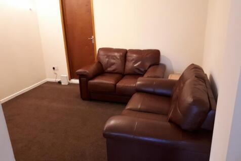 A cozy living room featuring comfortable leathe...