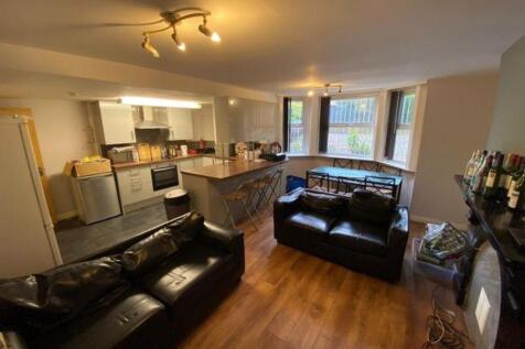 Spacious and modern open-plan living room featu...