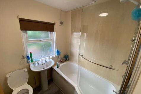 Bright and clean bathroom featuring a modern ba...