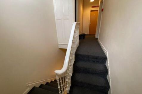 A clean and well-maintained hallway featuring a...